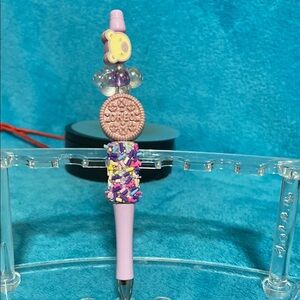 Purple Decorative Pen with Oreo cookie and sprinkles.